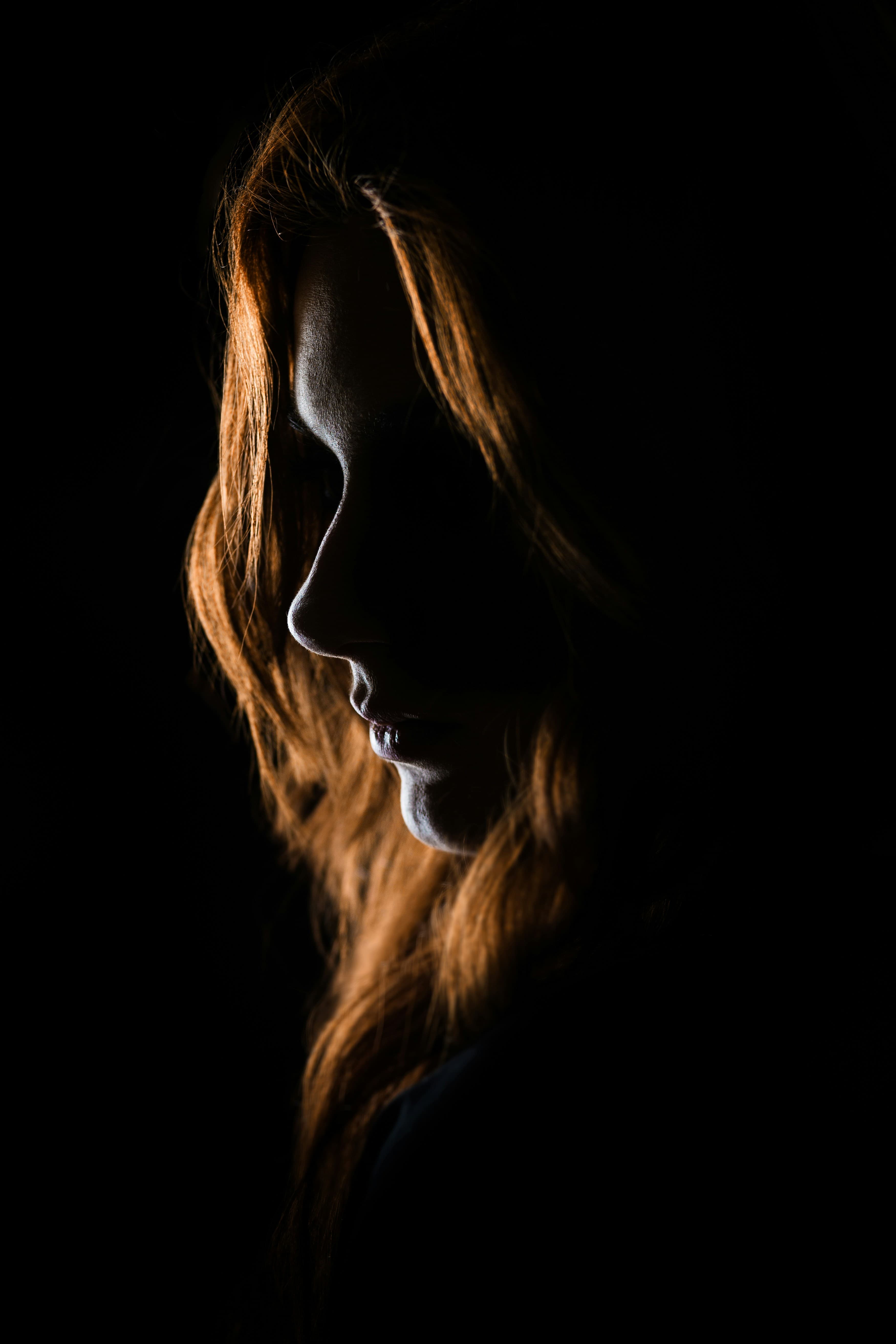A face half-lit against black
